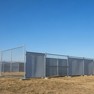 Various types of temporary fencing, including chain link and panel fencing, arranged for an event